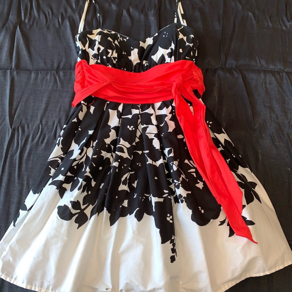 White Dress With Black Flowers and a Red Sash